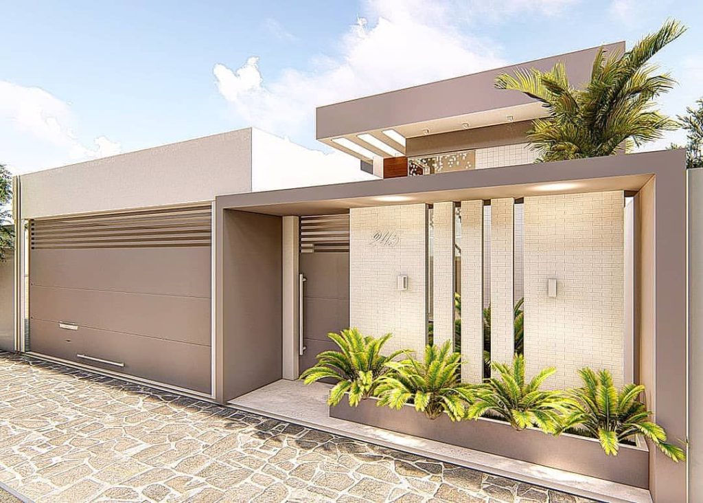 Muro e portão elegantes: Projeto Residencial Premium com jardim e revestimento.